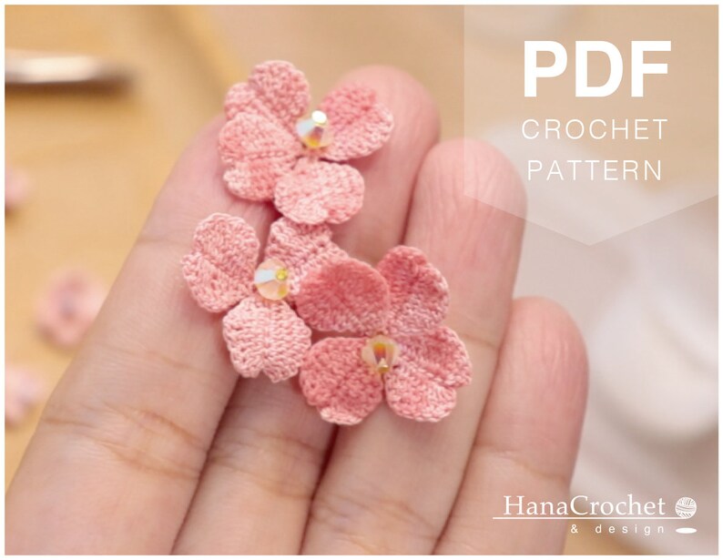 May include: A PDF crochet pattern for making delicate pink crocheted flowers. The pattern is available for download and includes instructions for creating the flowers.