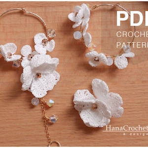 May include: PDF crochet pattern for a pair of white flower earrings and a single white flower brooch. The earrings are made with gold hoops and white crocheted flowers. The brooch is a single white crocheted flower.