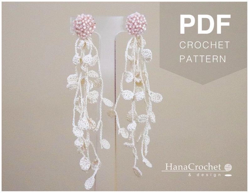 May include: PDF crochet pattern for a pair of white crocheted earrings with pink bead accents. The earrings are hanging from a display stand. The text "PDF CROCHET PATTERN" is displayed in the upper right corner of the image. The text "HanaCrochet & design" is displayed in the lower right corner of the image.