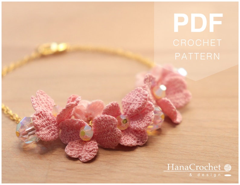 May include: A pink crochet bracelet with a gold chain and clear beads. The bracelet features a cluster of crocheted flowers. The text "PDF CROCHET PATTERN" is displayed at the top of the image. The text "HanaCrochet & design" is displayed at the bottom of the image.
