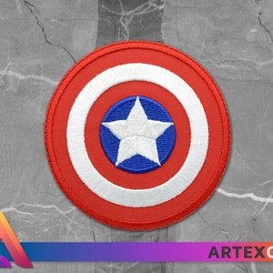 May include: A red, white, and blue embroidered patch featuring a white star on a blue circle surrounded by a white circle and a red outer circle.