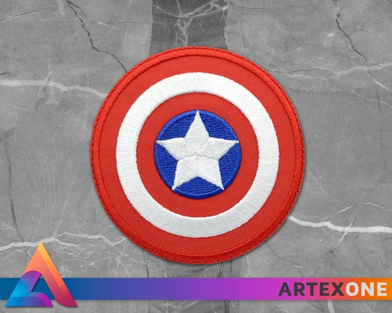 May include: A red, white, and blue embroidered patch featuring a white star on a blue circle surrounded by a white circle and a red outer circle.