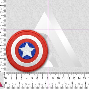 May include: A red, white, and blue embroidered patch featuring Captain America's shield. The shield is circular with a white star in the center on a blue background. The star is surrounded by a white circle, which is surrounded by a red circle.