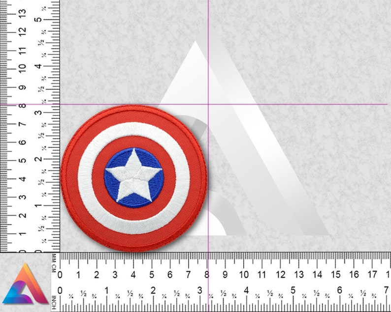 May include: A red, white, and blue embroidered patch featuring Captain America's shield. The shield is circular with a white star in the center on a blue background. The star is surrounded by a white circle, which is surrounded by a red circle.