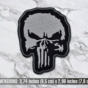 May include: A black and white embroidered patch of the Punisher skull. The skull is 3.74 inches (9.5 cm) wide and 2.99 inches (7.6 cm) tall.
