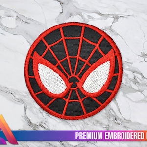 Può includere: Toppa ricamata rossa e nera con un design a ragnatela e occhi bianchi. La toppa dice "PREMIUM EMBROIDERED PATCH" in basso.