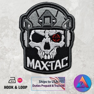 May include: Embroidered patch featuring a skull wearing a tactical helmet. The skull has a red target in one eye and the text "MAX-TAC" below. The patch is black, white, and gray.