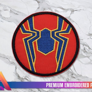 May include: Red, blue and gold embroidered patch of a spider with a black outline. The spider is on a red background and has a black outline. The patch is circular and has a black border.