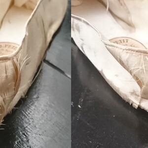 May include: Close-up of the inside of a cream-colored ballet slipper with frayed edges. The slipper is made of a soft, delicate fabric and has a label that reads "J. Petit, Paris".