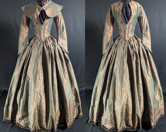 May include: A long-sleeved, green and gold dress with a high collar and a fitted bodice. The dress has a full skirt and a velvet trim.