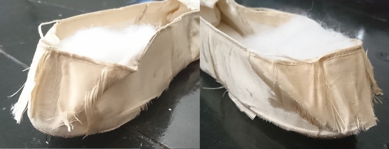 May include: A pair of beige fabric ballet slippers with frayed edges. The slippers are unlined and have a white cotton filling.