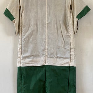 May include: A white and green Japanese kimono with a long, flowing design. The kimono has a white top and a green bottom. The kimono is made of a soft, lightweight fabric.