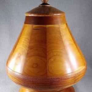 Precious Urn handsomely designed from Cherry Hardwoods and crowned with stained glass butterfly