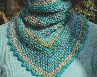 May include: A teal, blue, and green crocheted scarf with a scalloped edge.