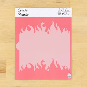 May include: Pink plastic cookie stencil with a flame design. The stencil is labeled "Cookie Stencils" and "Confection Couture".