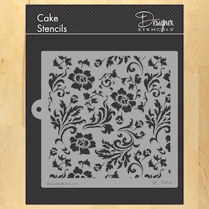 May include: A black and white floral stencil for cake decorating. The stencil is made of durable plastic and features a repeating pattern of flowers and leaves. The stencil is labeled "Designer Stencils" and "C816".