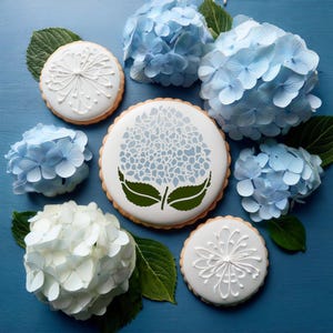 May include: A set of six decorated cookies featuring a blue hydrangea flower design. The cookies are decorated with white icing and are surrounded by blue hydrangea flowers.