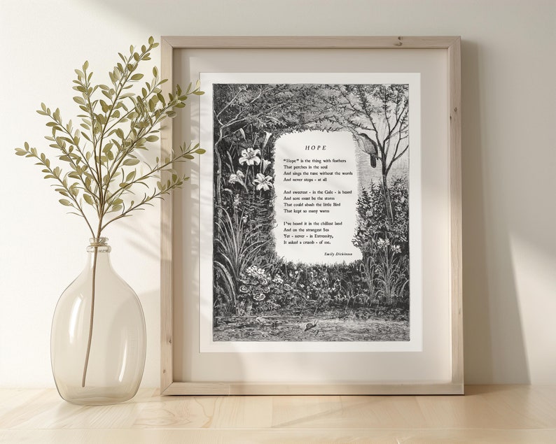 May include: A black and white print of a poem titled "Hope" by Emily Dickinson. The poem is set against a backdrop of a forest scene with a bird perched on a branch. The print is framed in a light wood frame.