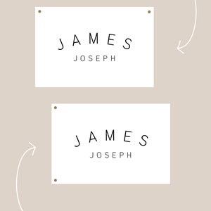 May include: Two white rectangular signs with the text "JAMES JOSEPH" printed in black. The top sign shows grommets in the top two corners, while the bottom sign shows grommets on the left and right sides. Text below the signs reads "BY DEFAULT GROMMETS WILL BE PLACED AT TOP TWO CORNERS" and "BUT YOU CAN REQUEST TO HAVE THEM ON THE LEFT SIDE (OR RIGHT)".