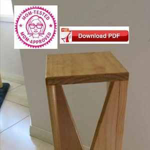 May include: A wooden side table with a unique angled design. The table is made of light brown wood and has a simple, modern style.