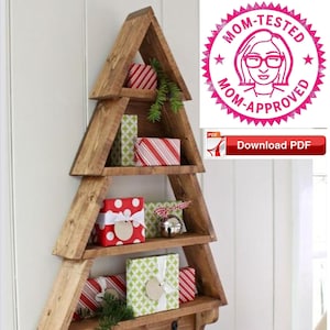 May include: A wooden Christmas tree shelf with four shelves and three hooks. The shelves are decorated with wrapped gifts in red, green, and white paper. The shelf is mounted on a white wall.