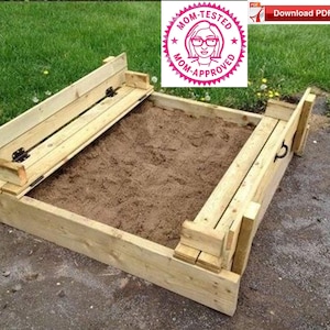 May include: A wooden sandbox with two hinged benches that fold down to create a lid. The sandbox is filled with sand and is surrounded by grass.
