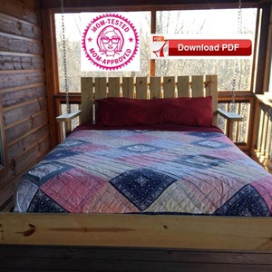 May include: A wooden swing bed with a red pillow and a patterned quilt. The bed is hanging from the ceiling of a porch with a wooden railing.