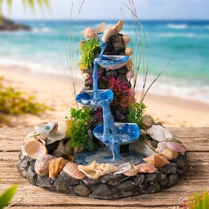 May include: A set of three ceramic mugs with a speckled, matte finish. The mugs are in shades of cream, light gray, and dark gray. Each mug has a simple, minimalist design, perfect for coffee or tea.