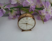 Swiza 7 Jewel alarm clock, small round Swiss made vintage working manual wind up clock in gold tone case