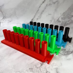 May include: A set of three ceramic mugs with a speckled, matte finish. The mugs are in shades of cream, light gray, and dark gray. Each mug has a simple, minimalist design, perfect for coffee or tea.