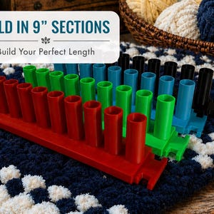 May include: A multi-colored knitting loom with red, green, blue, and black pegs. The text "SOLD IN 9" SECTIONS" and "Build Your Perfect Length" is displayed on a white banner. The loom sits on a blue and white patterned surface.
