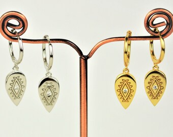 May include: Two pairs of hoop earrings with a dangling teardrop-shaped charm. The charms feature a geometric design with a small clear rhinestone in the center. One pair is silver and the other is gold.