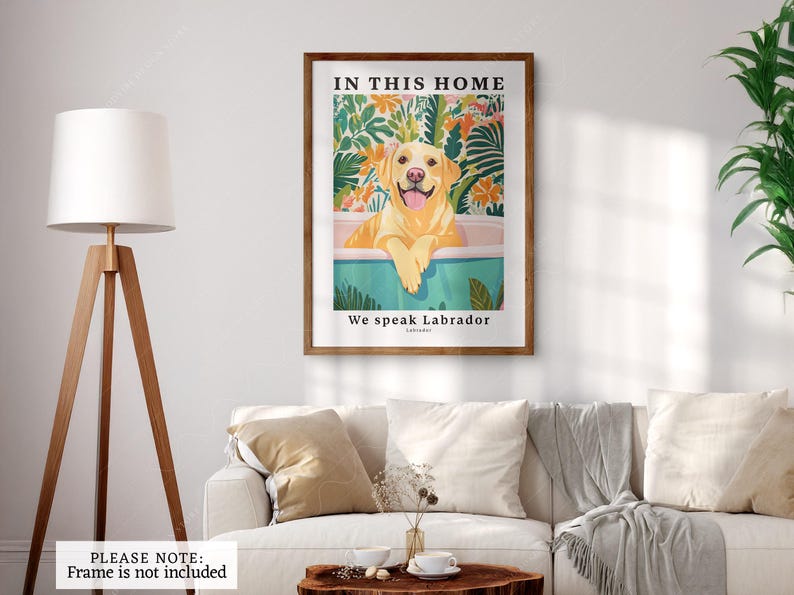 May include: A framed print with a yellow Labrador Retriever sitting in a bathtub. The print has a tropical background and the text "In this home we speak Labrador" at the bottom.