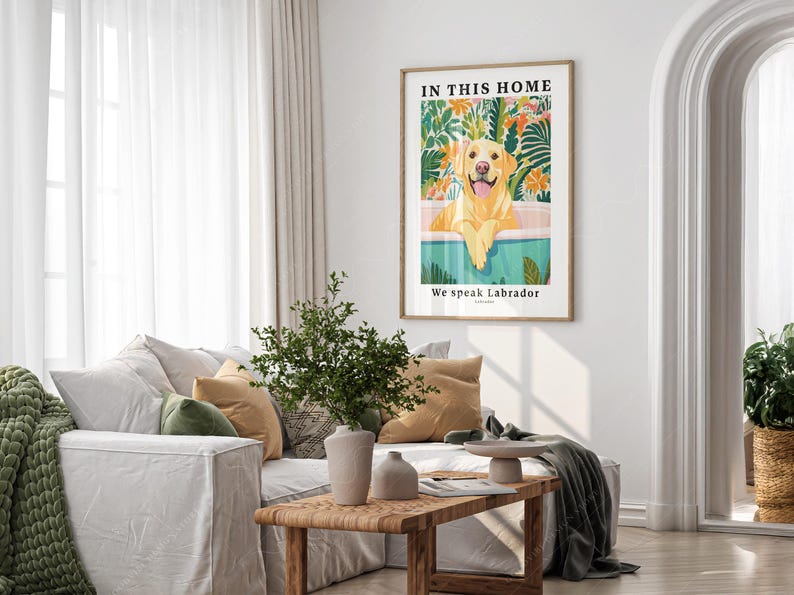 May include: A framed print with a yellow Labrador Retriever sitting in a pool of water surrounded by tropical plants. The text "In this home we speak Labrador" is printed below the image.