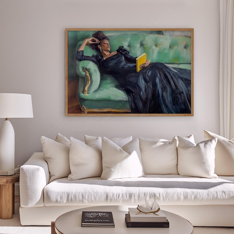 Puede incluir: Una pintura enmarcada de una mujer con un vestido negro tumbada en un sof&aacute; de terciopelo verde, sosteniendo un libro amarillo. El sof&aacute; tiene detalles dorados y est&aacute; en una habitaci&oacute;n con paredes blancas.
