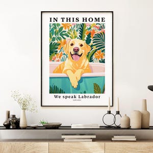 May include: A colorful illustration of a yellow Labrador Retriever sitting in a bathtub with green and white floral accents. The text "In this home we speak Labrador" is printed below the image.