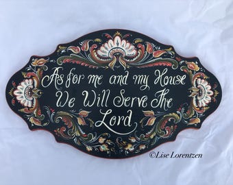 May include: Oval, black wooden sign with ornate floral designs in red, gold, and cream. The sign features the text "As for me and my House We Will Serve The Lord" in elegant white script. The artist's name is in the bottom right corner.