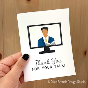 May include: A white card with a black computer screen image showing a person in a blue suit and yellow tie. The text "Thank You for Your Talk!" is below the image. The text "Olive Branch Design Studio" is in the bottom right corner.
