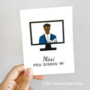 May include: A white card with a black computer monitor on it. The monitor shows a cartoon of a man in a blue suit and a yellow tie. The text on the card reads "Mesi pou diskou w!" and "Olive Branch Design Studio".
