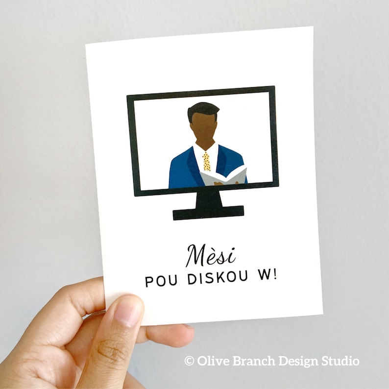 May include: A white card with a black computer monitor on it. The monitor shows a cartoon of a man in a blue suit and a yellow tie. The text on the card reads "Mesi pou diskou w!" and "Olive Branch Design Studio".