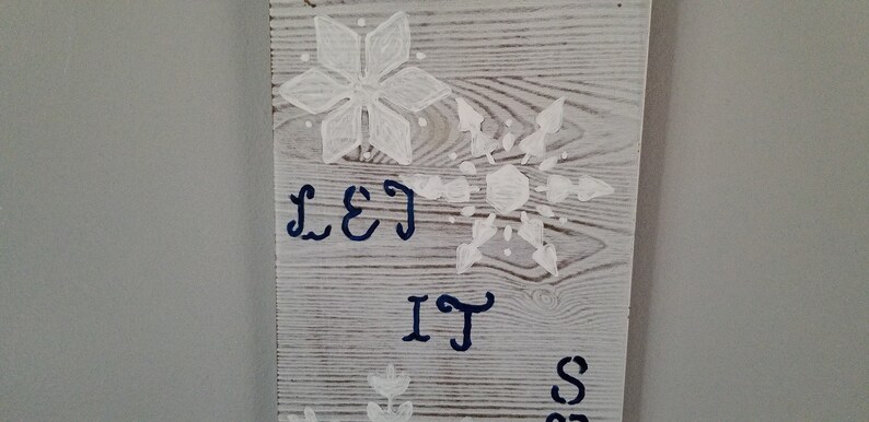 Must have. Great gift or decor for winter holidays size 4x12x18 On whitewash board stenciled with large snowflakes Sign Let It Snow