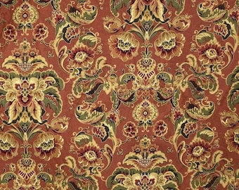 May include: A red fabric with a gold and green floral pattern. The pattern features large, intricate flowers with detailed leaves and swirls.