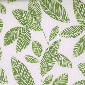 Könnte beinhalten: Ein weißer Stoff mit einem sich wiederholenden Muster aus grünen Blättern. Die Blätter haben ein gestreiftes Design.