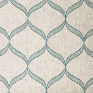 May include: Close-up of a fabric with a repeating teal, embroidered, curved pattern on a beige background. The design features interconnected, elongated ovals, creating a textured, decorative surface. The fabric appears to be linen or a similar natural fiber.