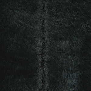 May include: Close-up of a dark gray textured fabric with a subtle sheen. The fabric has a vertical seam running down the center.