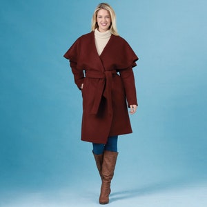 May include: A burgundy wrap coat with a wide collar and a self-tie belt. The coat has a long, flowing silhouette and is made of a soft, warm fabric.