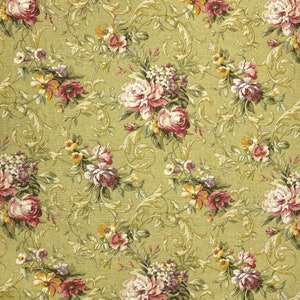 May include: A green fabric with a floral pattern. The flowers are in shades of pink, white, and yellow. The fabric has a vintage look.