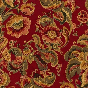May include: A red fabric with a repeating pattern of gold and brown floral designs. The fabric features a paisley-like pattern with intricate details.