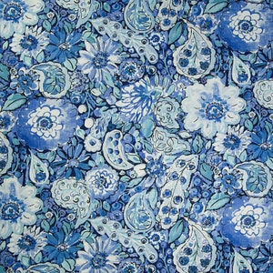 May include: A blue and white floral fabric with a paisley pattern. The fabric features a variety of flowers, leaves, and paisley designs in shades of blue and white.