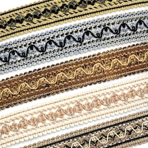 May include: Five different trims of decorative fabric trim with a black and gold pattern. The trims are arranged in a staggered pattern, with the top trim being the widest and the bottom trim being the narrowest.